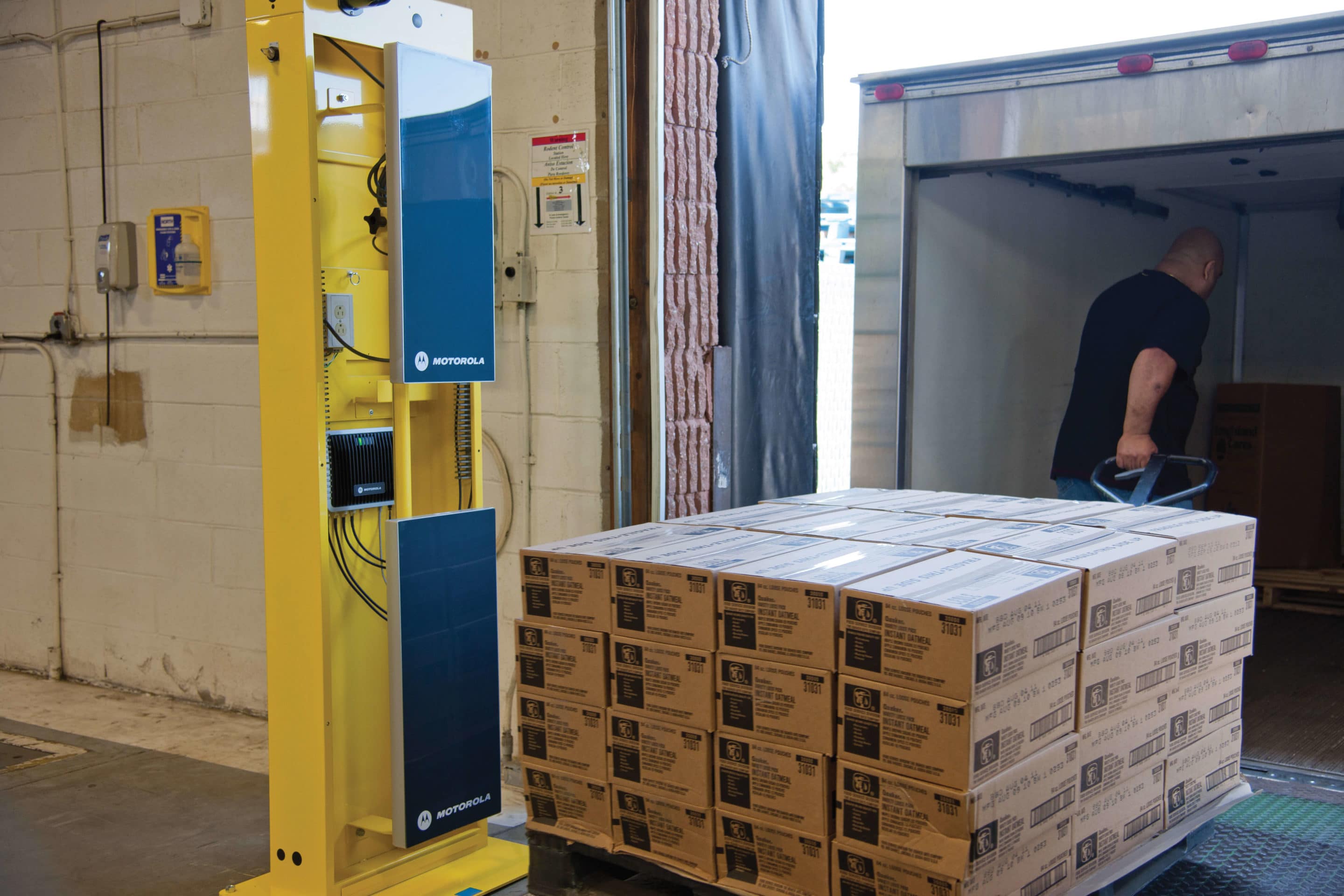 A Warehouse pallet getting loaded into a semi-truck with a hand lift after using Intelliworks and manufacturing execution systems